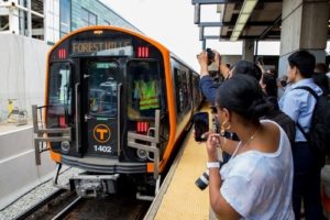 Subway train with people taking pictures of it