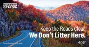 Anti-littering ad that says "Keep the Roads Clear, We Don't Litter Here"