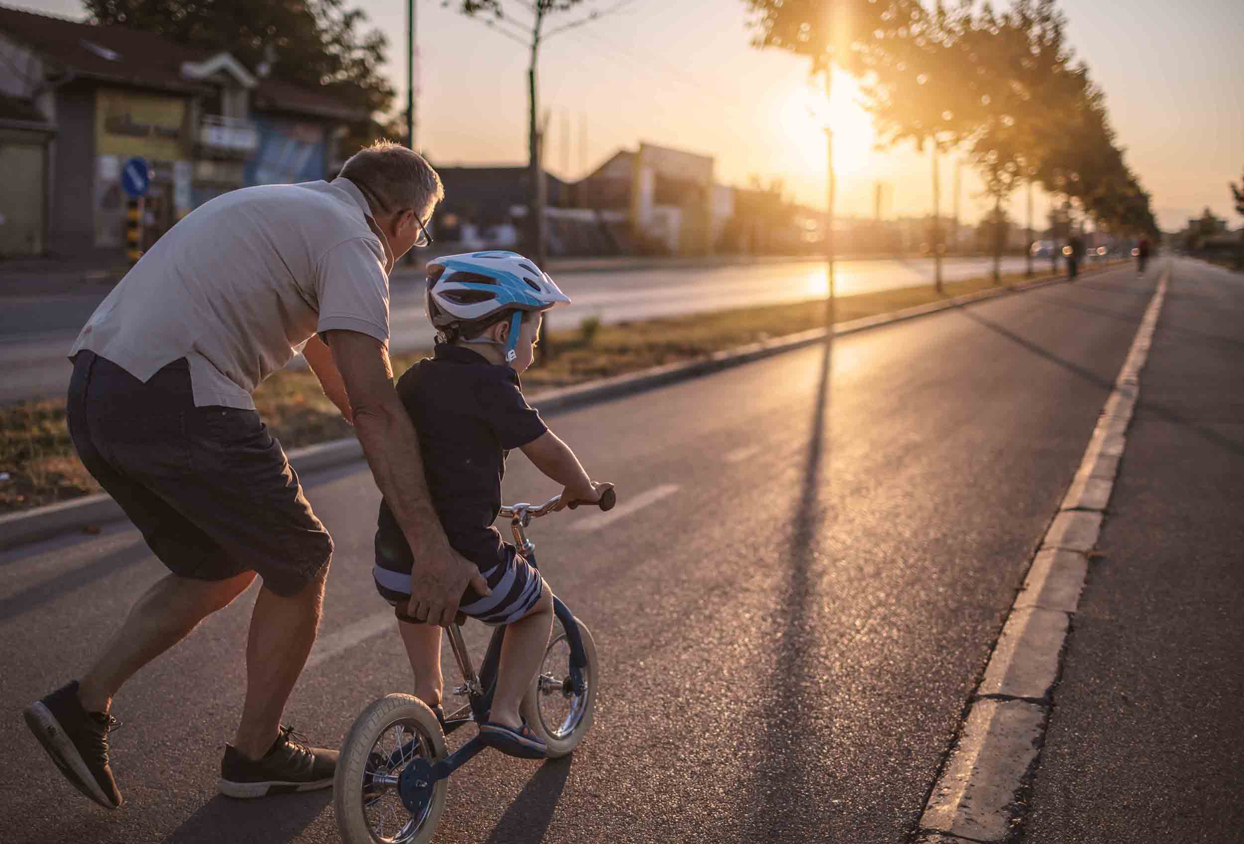 Grandfather teaching grandson biking