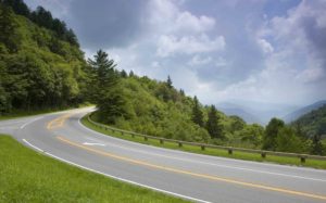 A road going through the lush green mountains