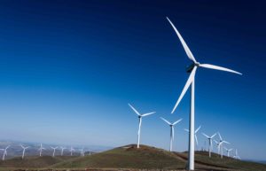 Wind turbines atop rolling hills