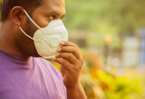 Man wearing face mask in park.