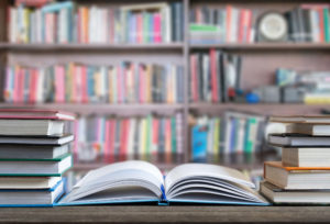 Textbooks sit on desk.