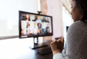 woman video conferences with coworkers.