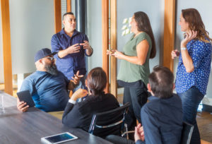 Woman leads meeting in conference room.