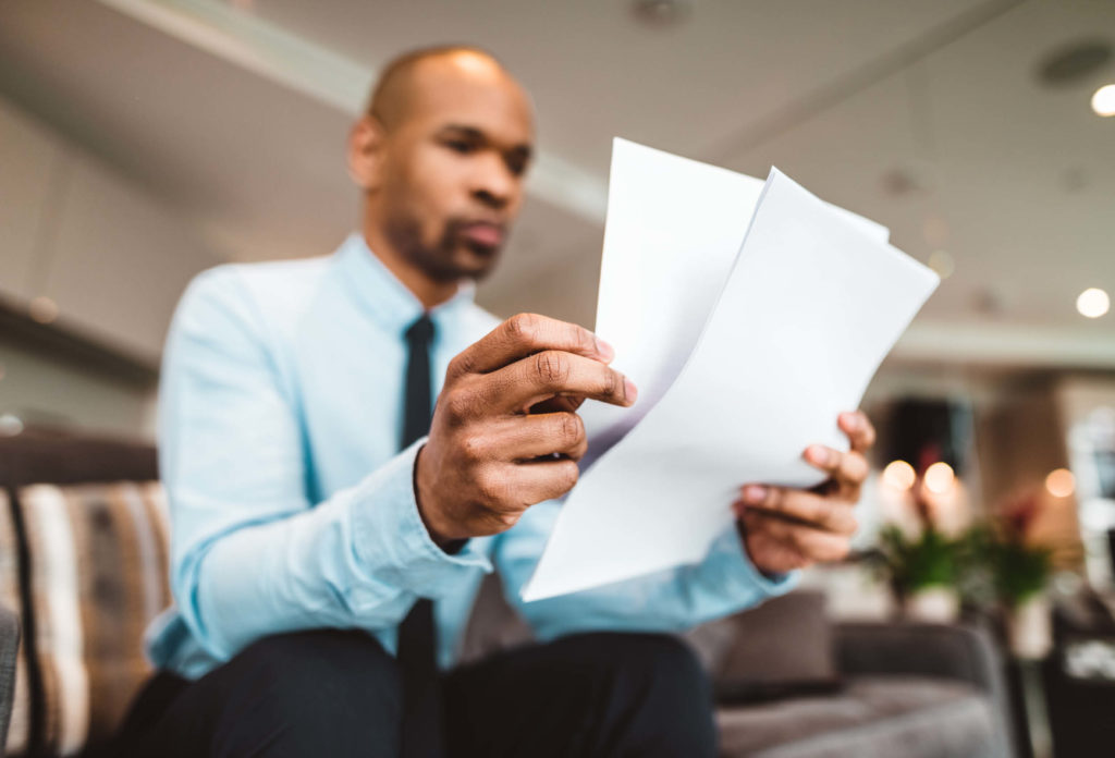 Business man reading through papers