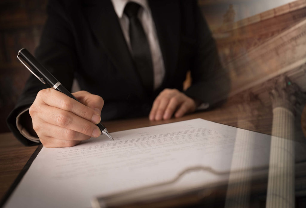 lawyer signing document, transposed over image of Supreme Court