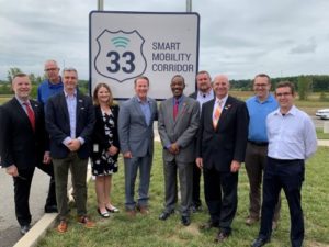 People in front of Smart Mobility Corridor sign