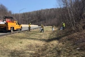 Workers picking up litter along the road