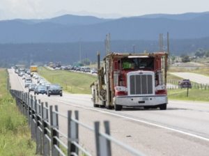 Truck and cars going down highway