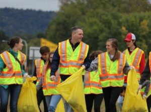 Group of people picking up litter