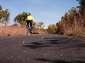 A person riding a bike down the road.