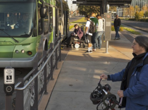 An electric wheelchair loading onto public transit.