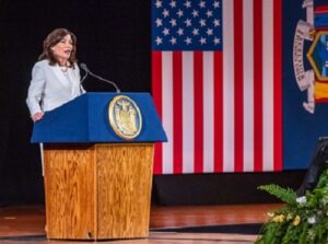 Woman giving a speech at a podium.