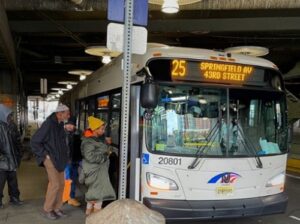 People getting on a bus.