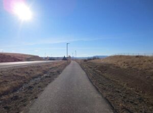 Open stretch of road from the sidewalk.